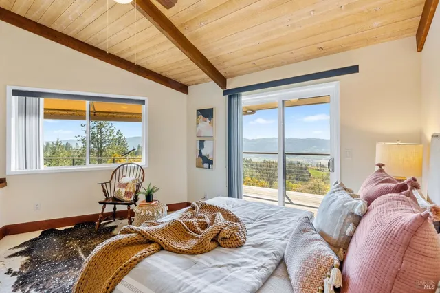 a living room with furniture a flat screen tv and a large window