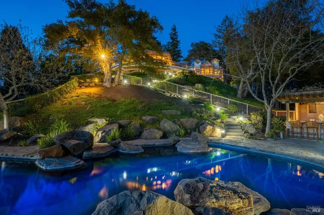 a view of a house with a small yard and a garden