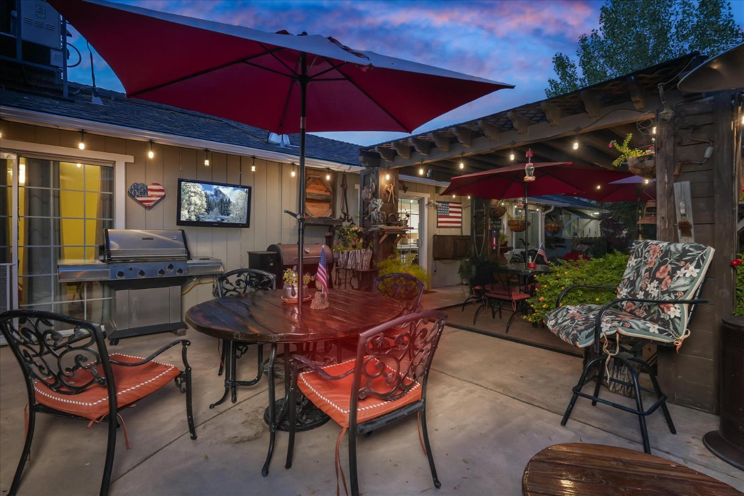 32583 River Knolls Road Coarsegold, CA 93614 - Photo 47 of 63 a view of a dining tables and chairs under an umbrella