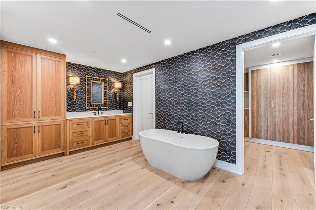 13945 Old Coast Road, Unit 905 Naples, FL 34110 - Photo 15 of 39 a large room with wooden floor and windows