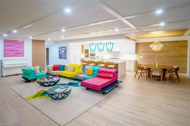 a living room filled with furniture and a wooden floor