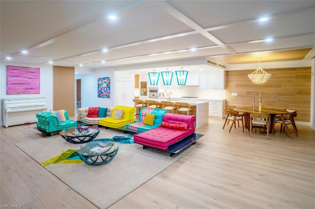 13945 Old Coast Road, Unit 905 Naples, FL 34110 - Photo 2 of 39 a living room filled with furniture and a wooden floor