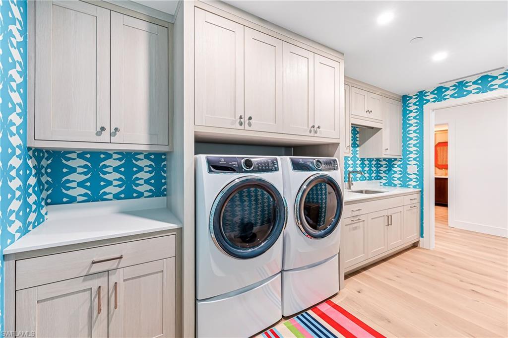 13945 Old Coast Road, Unit 905 Naples, FL 34110 - Photo 25 of 39 a utility room with sink dryer and washer