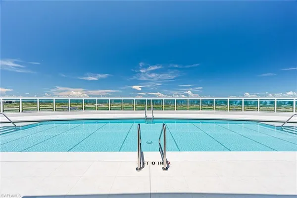 a view of a swimming pool with an outdoor space and seating area