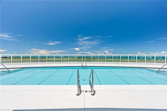 a view of a swimming pool with an outdoor space and seating area