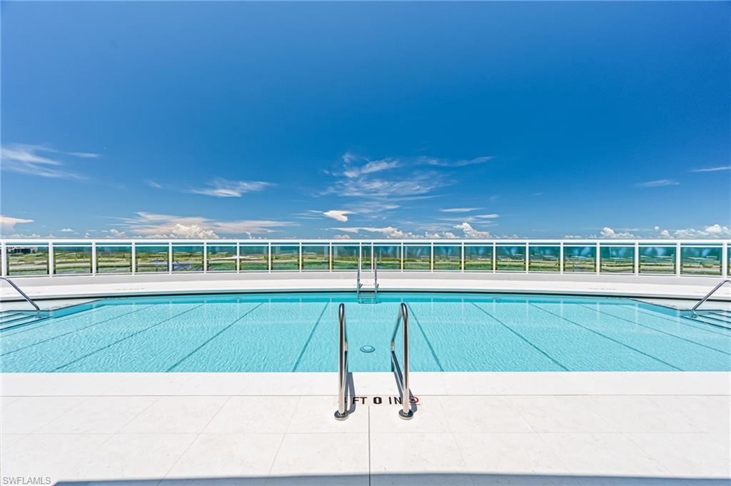 13945 Old Coast Road, Unit 905 Naples, FL 34110 - Photo 29 of 39 a view of a swimming pool with an outdoor space and seating area