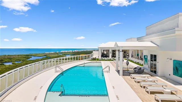a swimming pool with outdoor seating and yard