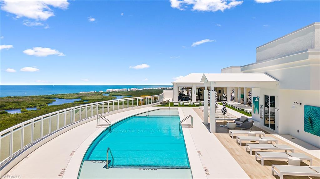 13945 Old Coast Road, Unit 905 Naples, FL 34110 - Photo 30 of 39 a swimming pool with outdoor seating and yard
