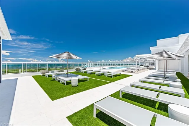 a view of house with swimming pool outdoor seating