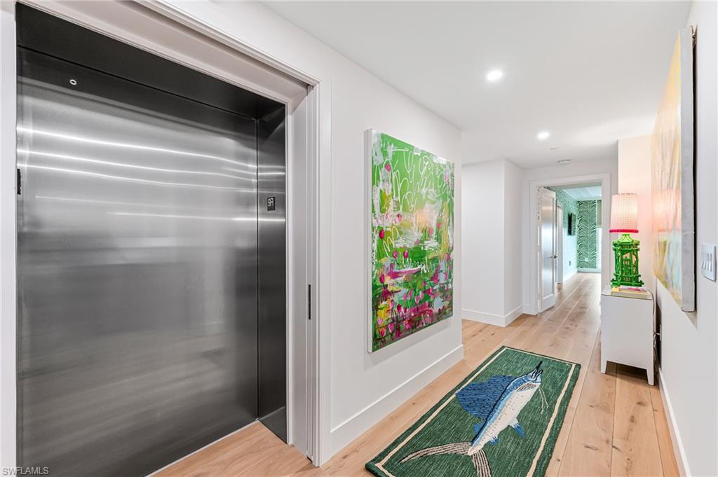 13945 Old Coast Road, Unit 905 Naples, FL 34110 - Photo 6 of 39 a hallway with a dining table and a entryway