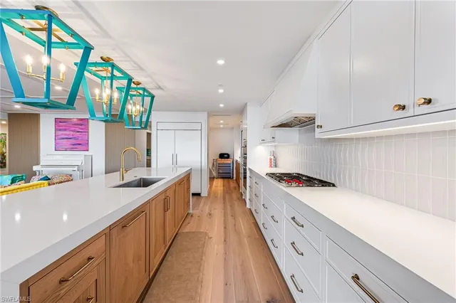 a kitchen with stainless steel appliances a sink and a stove
