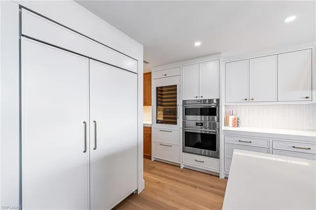 a kitchen with stainless steel appliances a refrigerator and cabinets