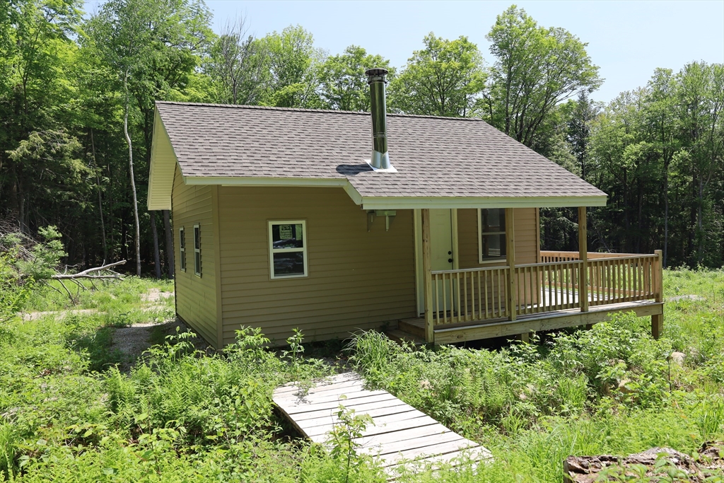 Lot 3 Yokum Pond Road Becket, MA 01223 - Photo 12 of 35 a front view of a house with a garden