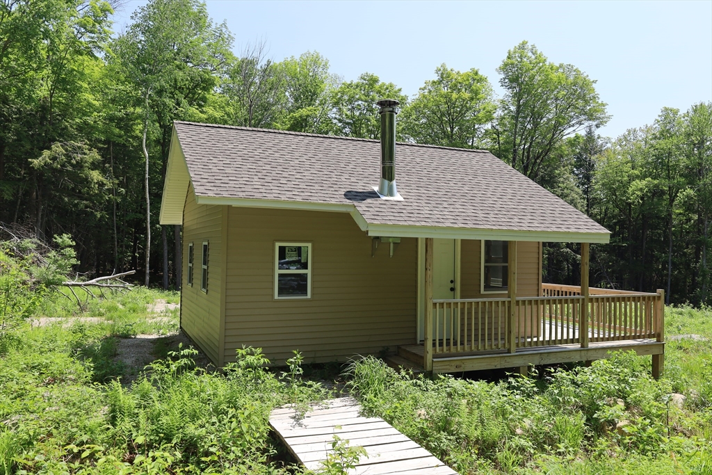 Lot 3 Yokum Pond Road Becket, MA 01223 - Photo 13 of 35 a front view of a house with a garden