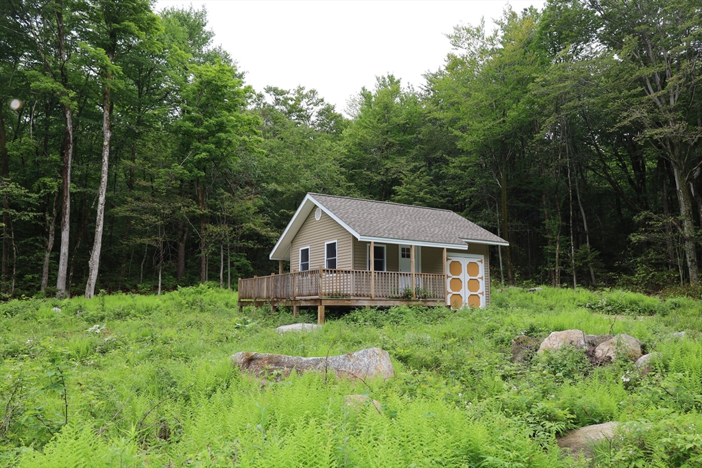 Lot 3 Yokum Pond Road Becket, MA 01223 - Photo 29 of 35 a house with green field in front of it