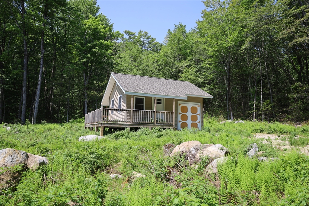 Lot 3 Yokum Pond Road Becket, MA 01223 - Photo 9 of 35 a house with green field in front of it