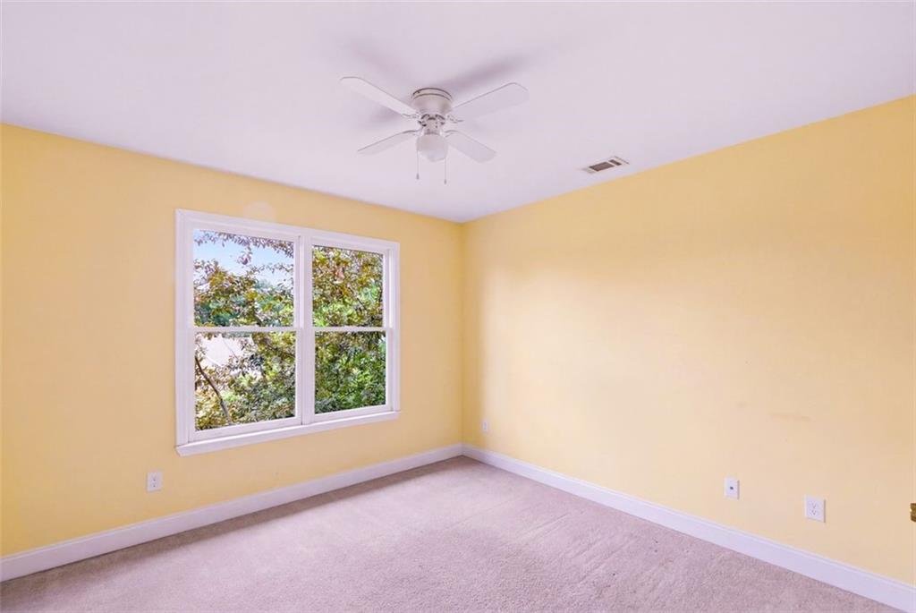 3420 Bulloch Lake Road Loganville, GA 30052 - Photo 44 of 57 an empty room with a window and a ceiling fan