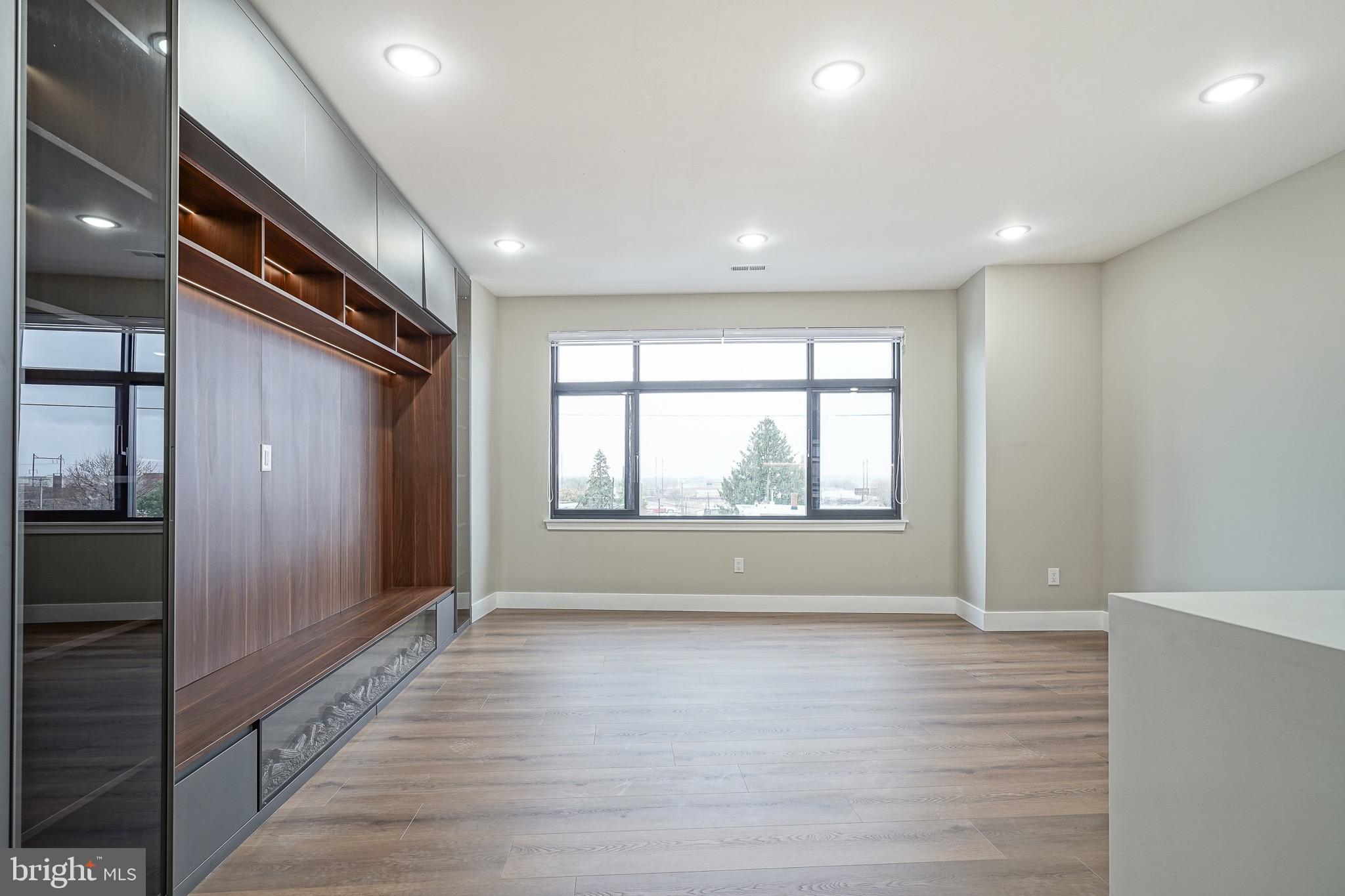 4432-00 Wingate Street, Unit 102 Philadelphia, PA 19136 - Photo 3 of 19 a view of hallway with a large window and wooden floor