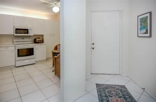 a kitchen with granite countertop a stove a sink and a refrigerator
