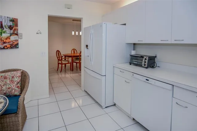 a kitchen with stainless steel appliances a refrigerator and cabinets
