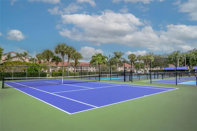 a green field with lots of trees