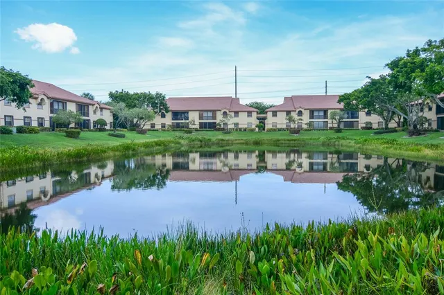 a view of a lake with a house in the background
