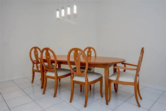 a view of a dining room with furniture and chandelier