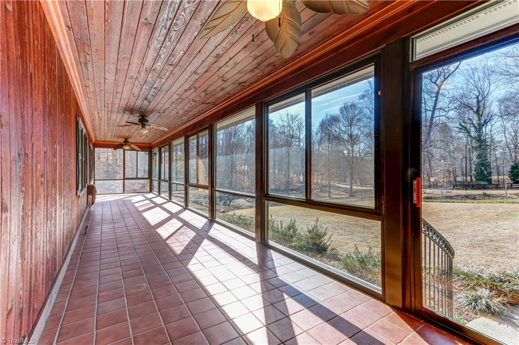 761 Hudson Road Summerfield, NC 27358 - Photo 2 of 28 Enclosed front porch with Tongue & Groove ceiling, three ceiling fans, and tile floor.