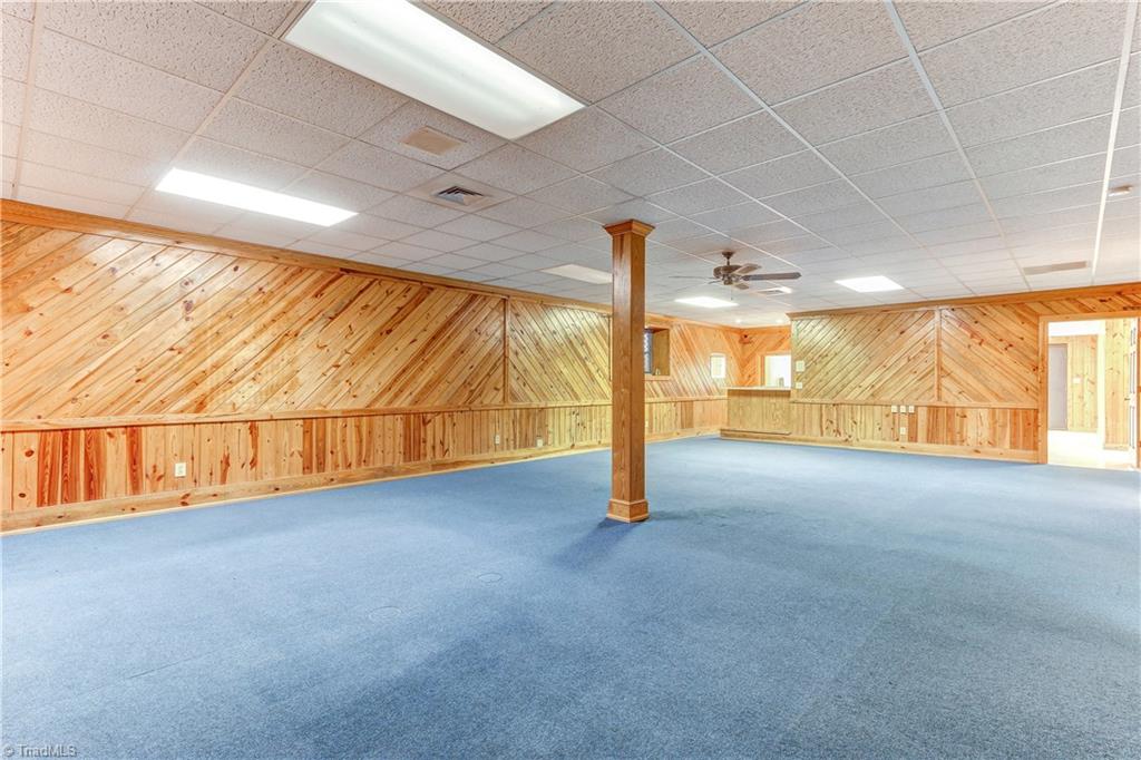 761 Hudson Road Summerfield, NC 27358 - Photo 17 of 28 Sound proofing was added to the entire lower level. I-Beam construction to reduce need for support columns. Acoustic tile ceiling, ceiling fan, Tongue and Groove wall covering and wall to wall carpeting.