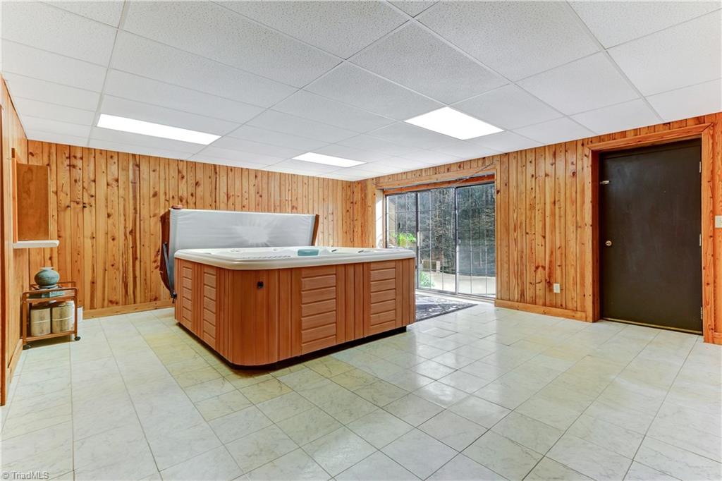 761 Hudson Road Summerfield, NC 27358 - Photo 20 of 28 The Spa Room has a direct wired Hot Springs 7-person therapeutic spa and plenty of additional space for a gym or other exercise equipment. Direct access to outdoor patio.