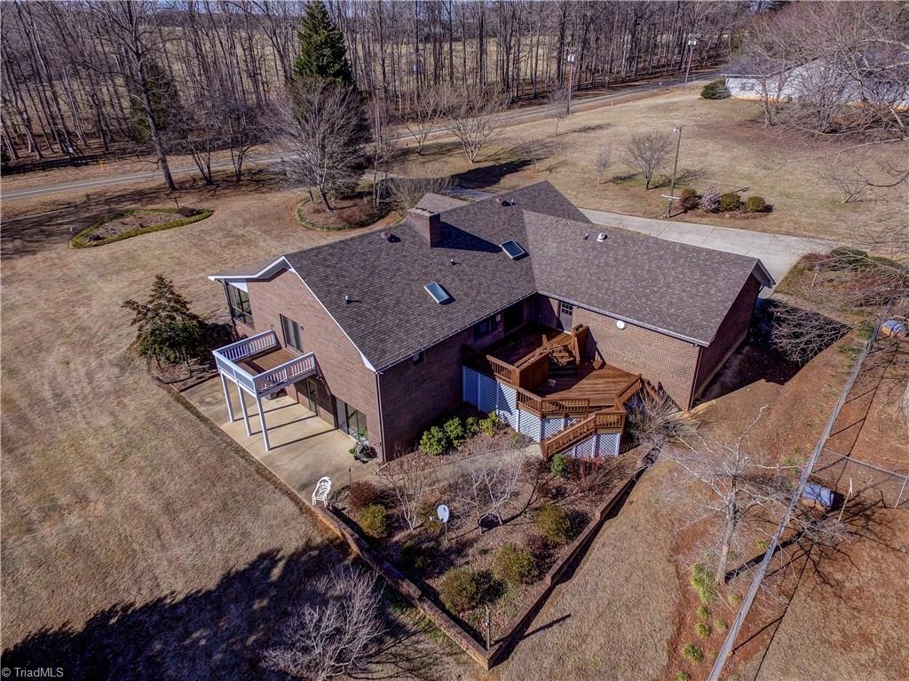 761 Hudson Road Summerfield, NC 27358 - Photo 24 of 28 Aerial view of the home showing the private Master Deck to the left and main deck off the Great Room to the right.