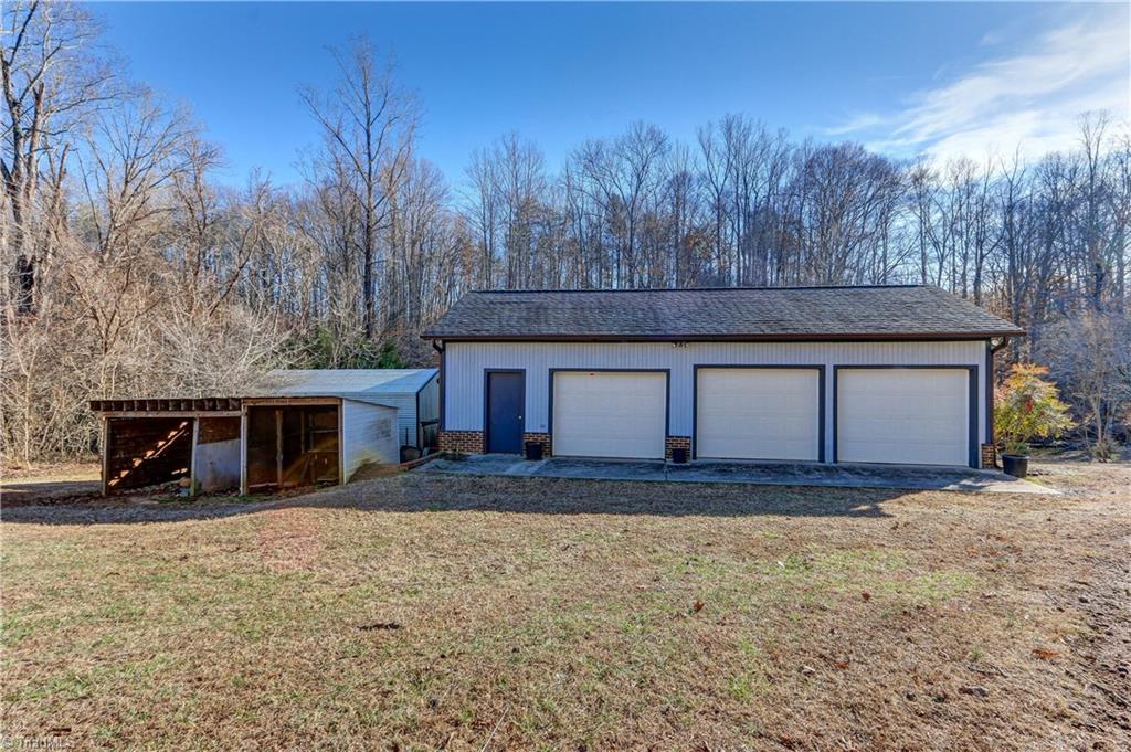 761 Hudson Road Summerfield, NC 27358 - Photo 25 of 28 Over-sized three car detached garage is outfitted for work with multi-outlet power strips powered by 2-circuits to prevent overload when using power tools.