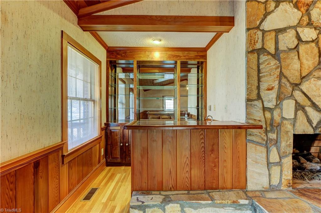 761 Hudson Road Summerfield, NC 27358 - Photo 5 of 28 Wet Bar off the Great Room has built in cabinetry and glass shelving.