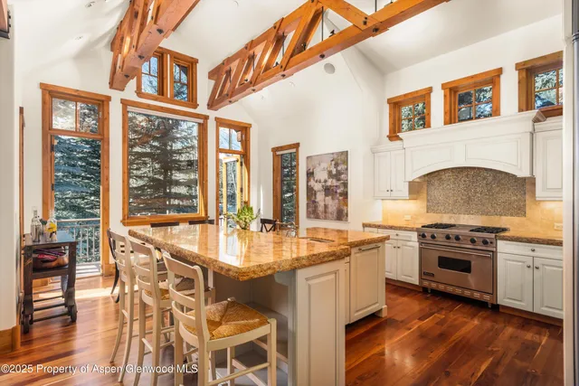 a kitchen with a stove a sink and cabinets