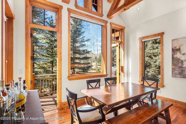 a dining room with furniture and wooden floor