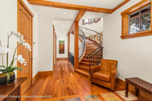 a living room with wooden floor and furniture