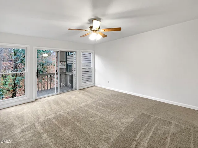 a view of a livingroom with a ceiling fan and window