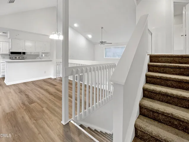 a view of a kitchen with wooden floor and electronic appliances