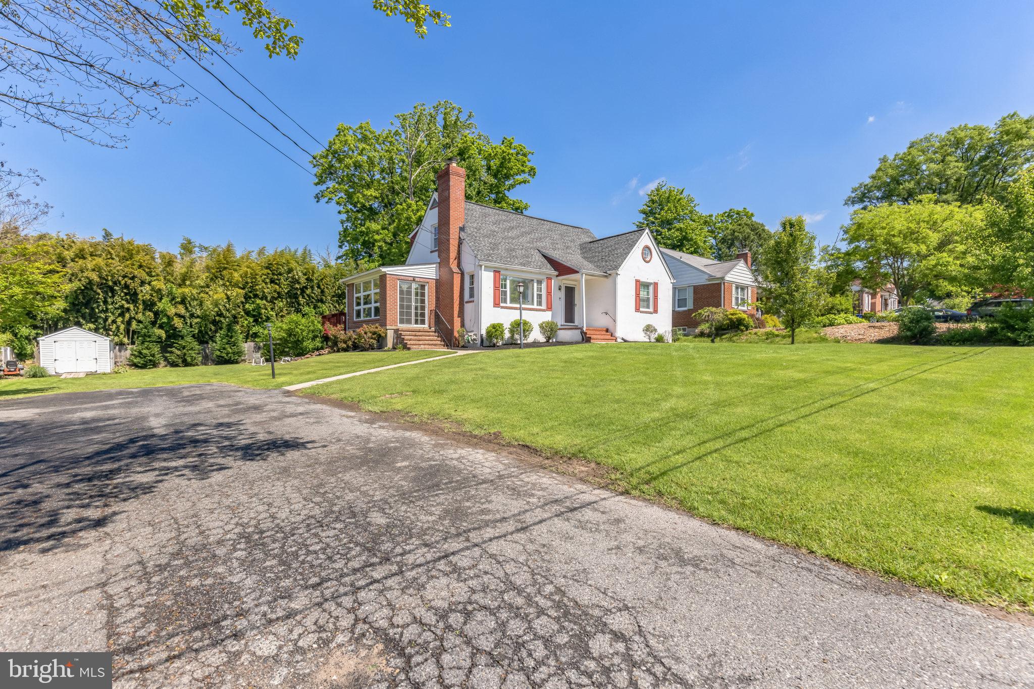 9408 Dana Vista Road Baltimore, MD 21236 - Photo 2 of 38 a front view of a house with a yard and garage