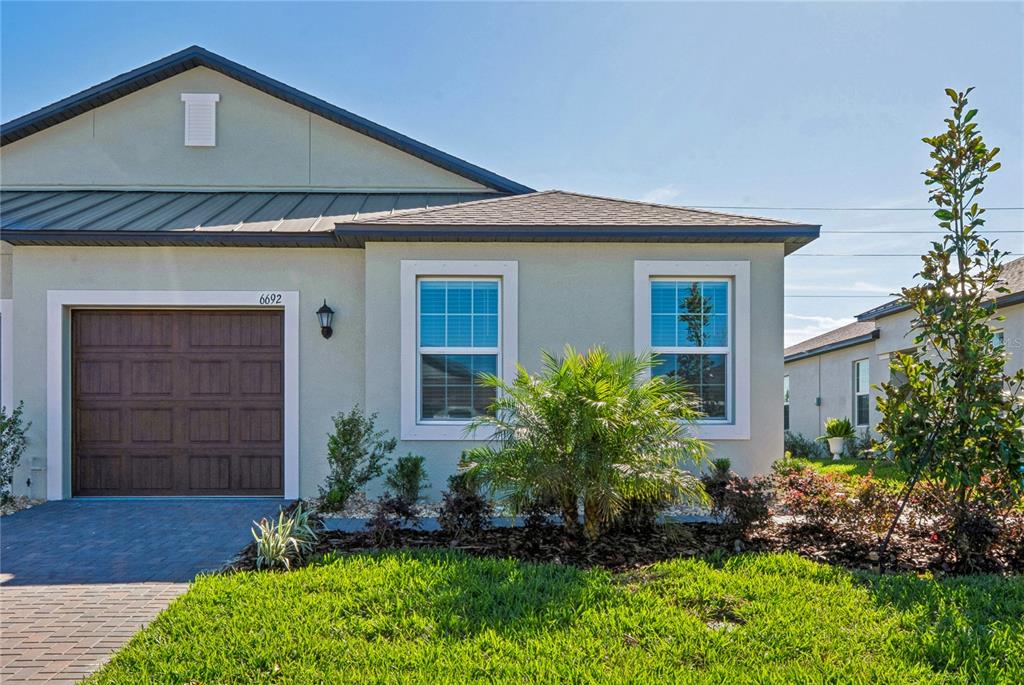 6692 Homebound Way New Port Richey, FL 34653 - Photo 2 of 47 a front view of a house with a yard