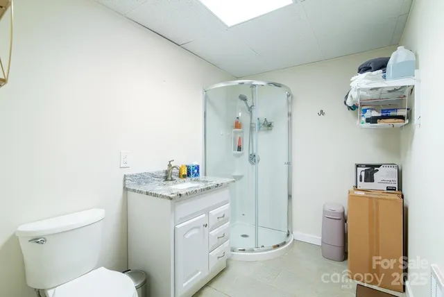 a bathroom with a granite countertop sink a toilet and a mirror