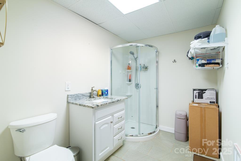47 Hummingbird Road Franklin, NC 28734 - Photo 11 of 16 a bathroom with a granite countertop sink a toilet and a mirror