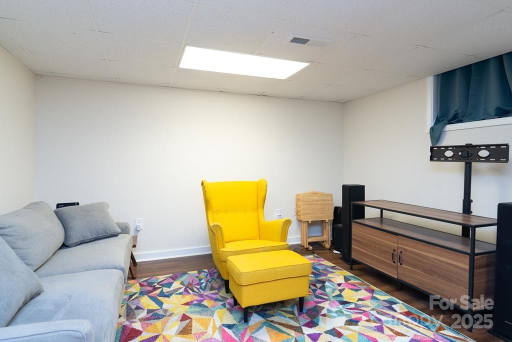 47 Hummingbird Road Franklin, NC 28734 - Photo 13 of 16 a living room with furniture and a baby crib with wooden floor