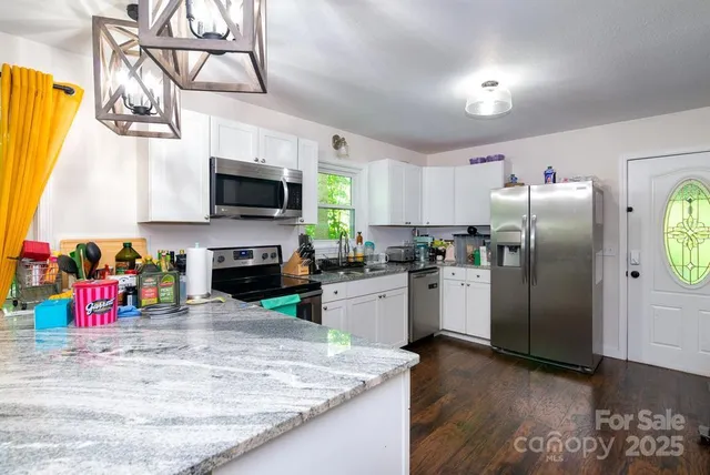 a kitchen with refrigerator and microwave