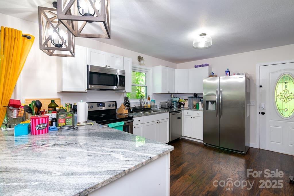 47 Hummingbird Road Franklin, NC 28734 - Photo 4 of 16 a kitchen with refrigerator and microwave
