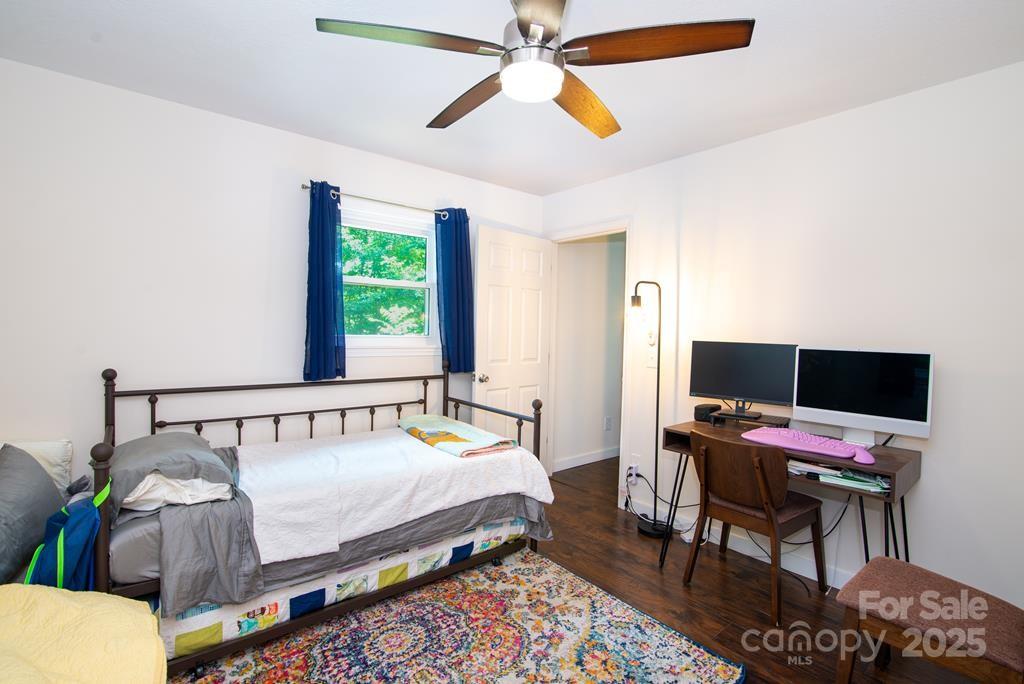 47 Hummingbird Road Franklin, NC 28734 - Photo 7 of 16 a bedroom with a bed and a chandelier