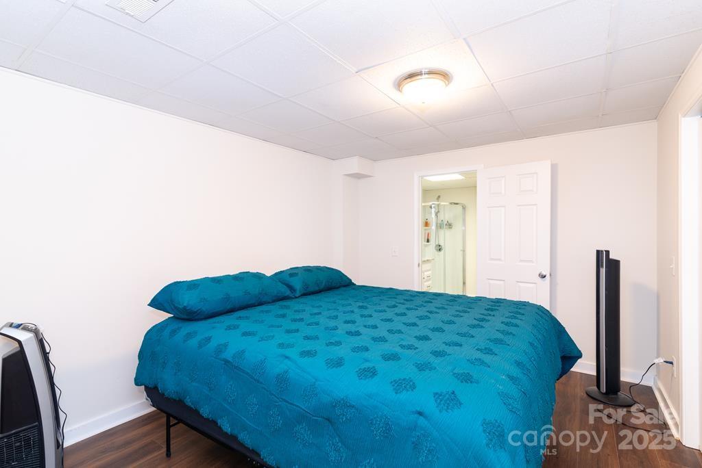 47 Hummingbird Road Franklin, NC 28734 - Photo 10 of 16 a bedroom with a bed window and a potted plant