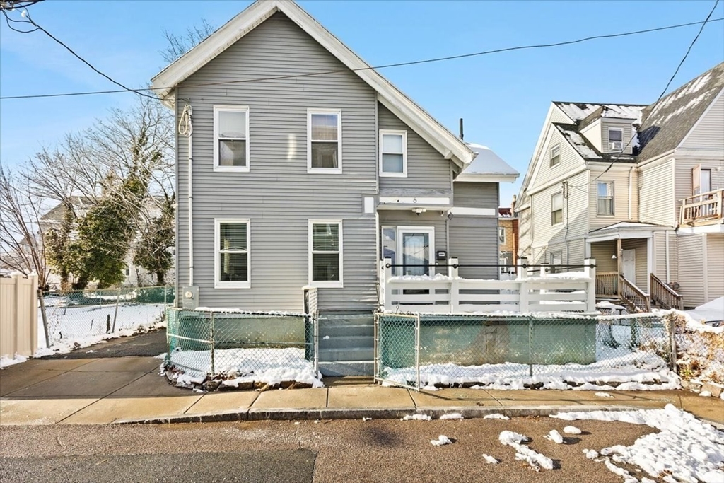 a front view of a house with a yard glass windows and a sink