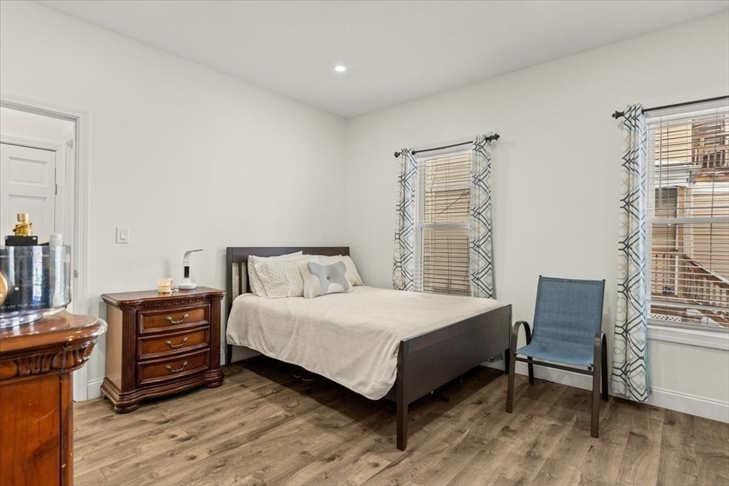 6 Arion Street Boston, MA 02125 - Photo 12 of 42 a bedroom with a bed and a dresser in it