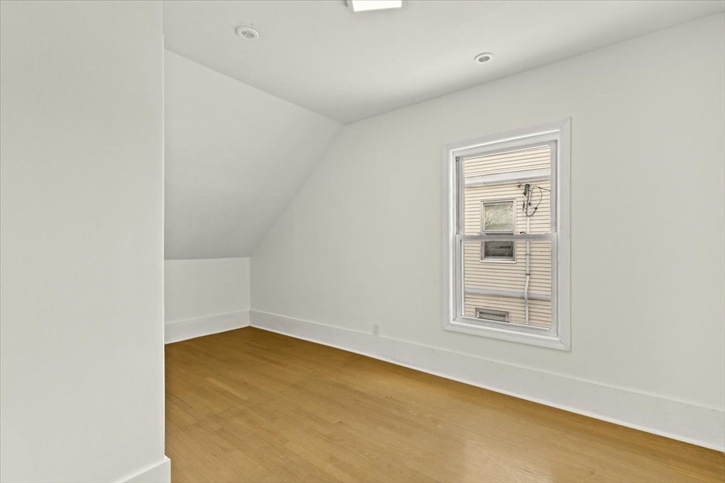 6 Arion Street Boston, MA 02125 - Photo 22 of 42 an empty room with a empty space and windows